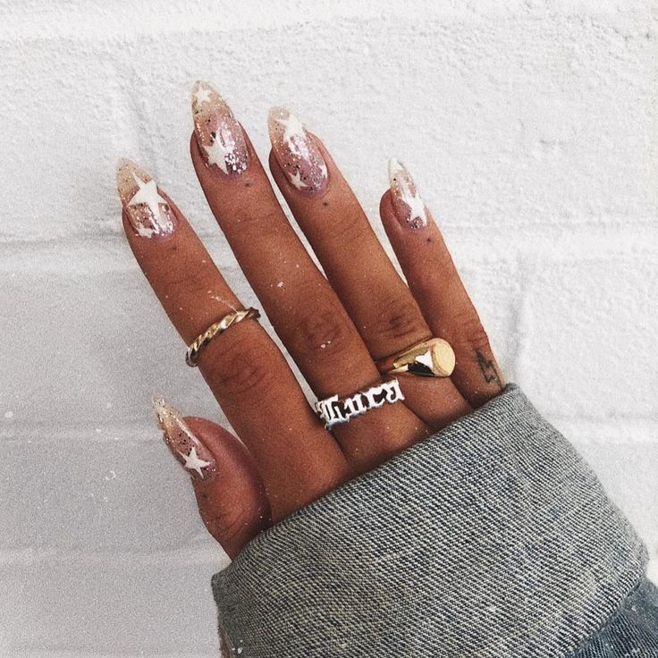 Chic Nude and Sparkly Nail Design with Star Motifs and Complementary Rings