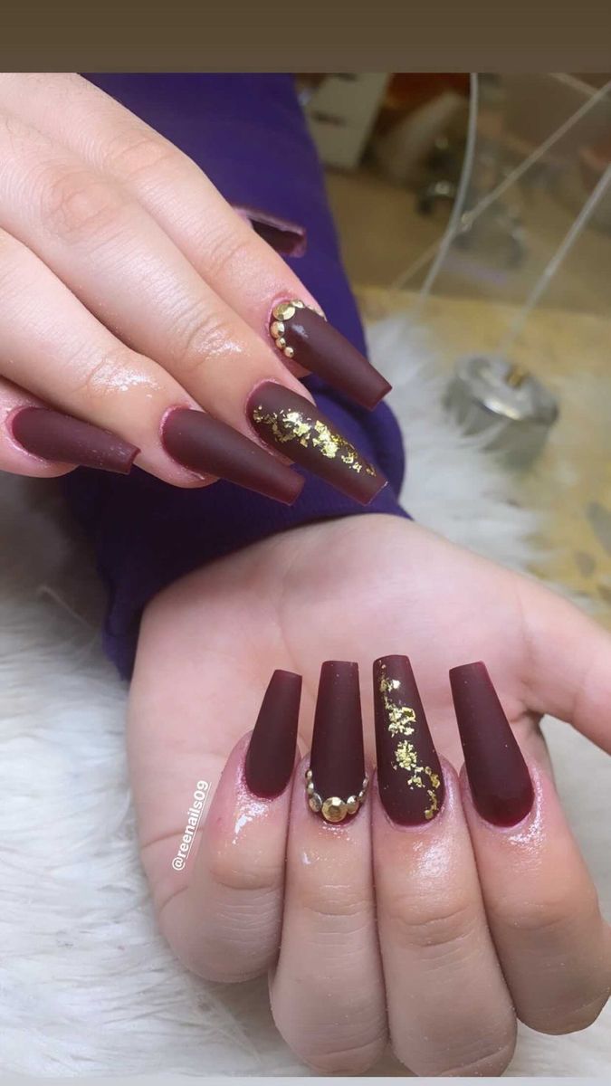 Chic Deep Burgundy Matte Nail Design with Glossy Accents and Glamorous Gold Foil Details.