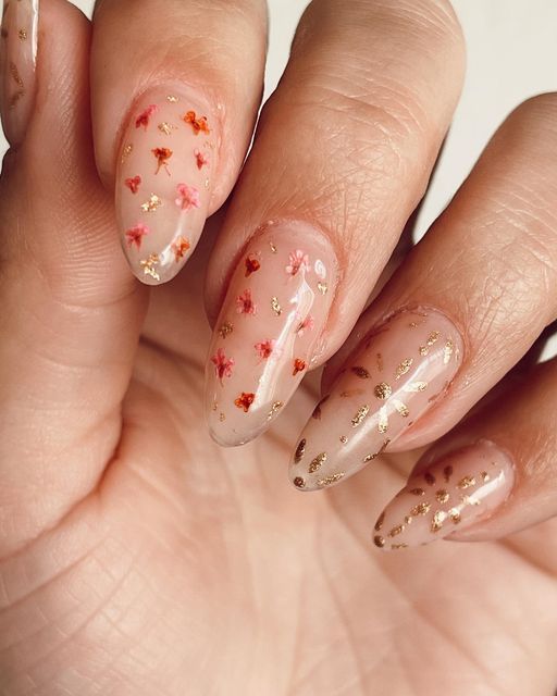 Delicate Floral Nail Art with Gold Accents on Translucent Nude Base