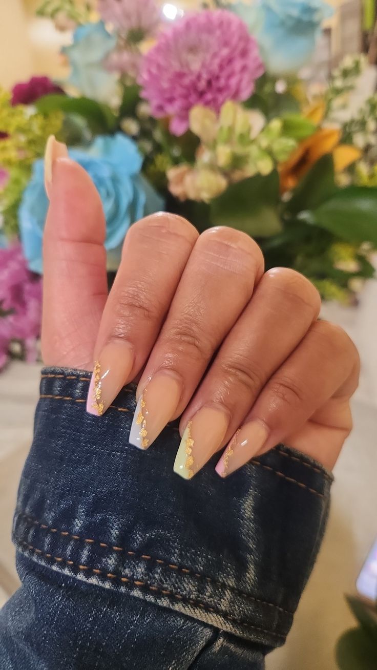 Sophisticated Nail Design with Soft Gradient and Gold Foil Accents Against a Floral Backdrop