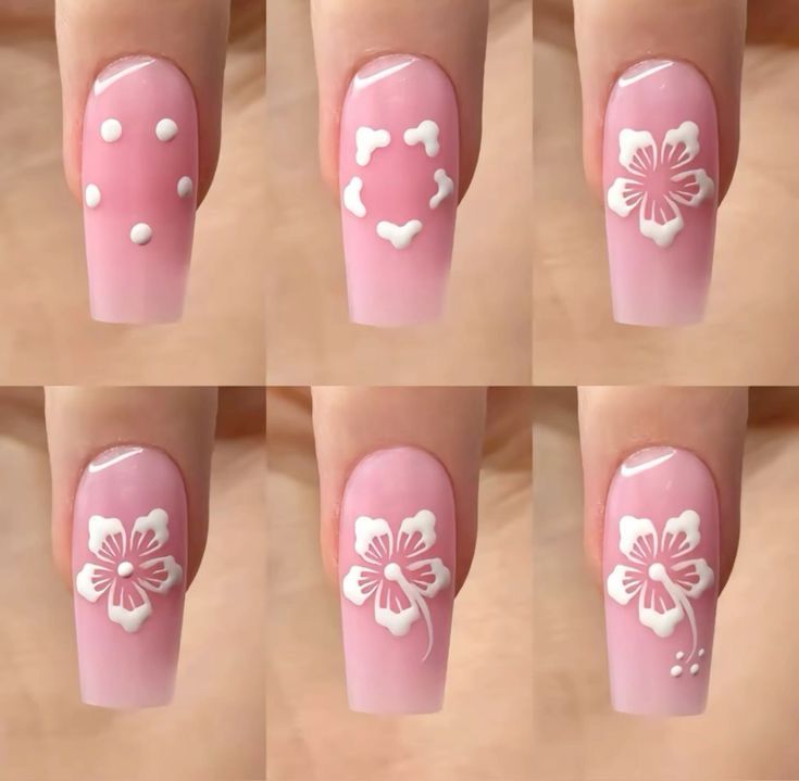 Elegant Pastel Pink Nail Art with Delicate White Floral Patterns.