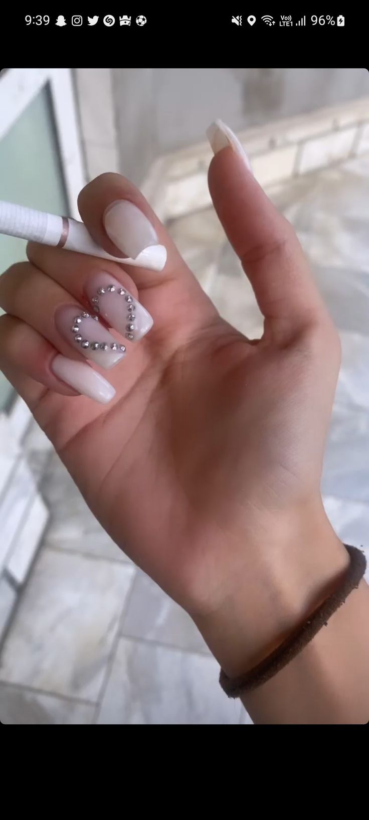 Elegant White Nail Design with Silver Rhinestone Hearts for Playful Romance