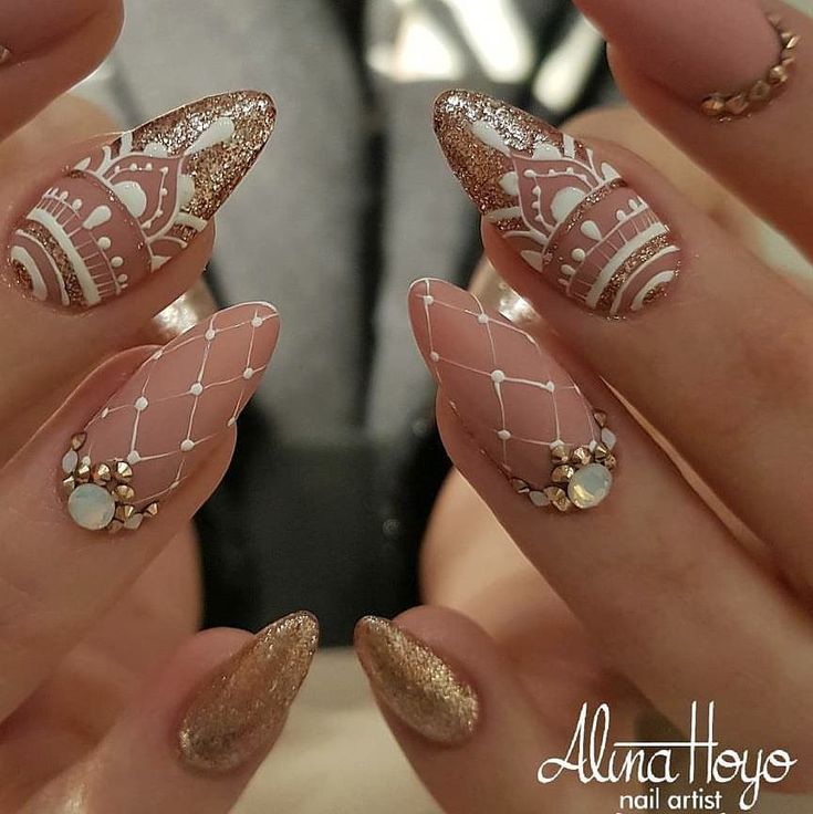 Chic Nail Design: Soft Pink and Shimmering Gold with Intricate White Patterns