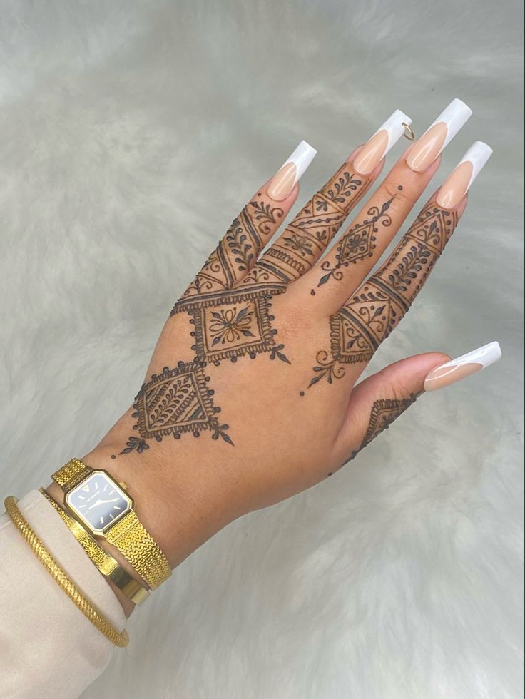 Elegant Long Nude Acrylic Nails with White Tips and Intricate Henna Patterns.