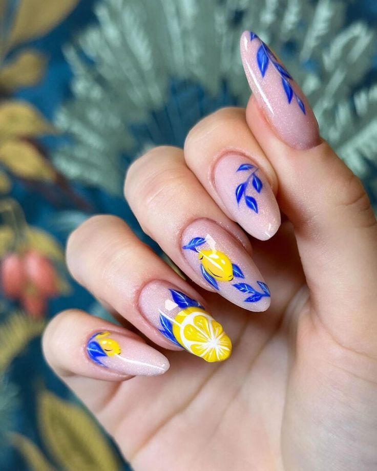 Elegant Summer Nail Design: Delicate Lemon Motifs with Blue Leaf Accents on Soft Nude Polish.