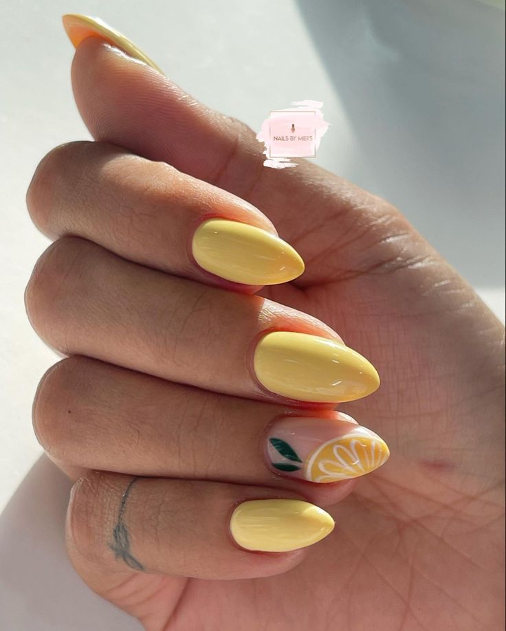 Cheerful Vibrant Yellow Almond-Shaped Nail Design with Floral Accent