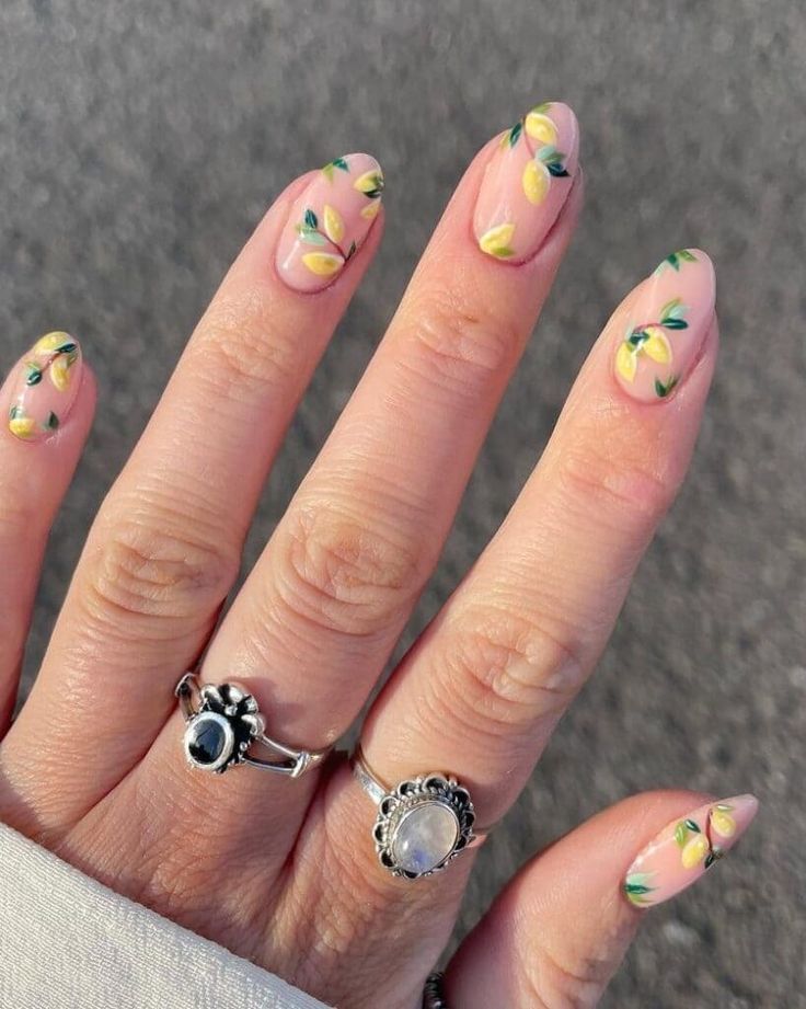 Vibrant Floral Nail Design with Lemon and Green Leaf Motifs for a Playful Spring/Summer Look.