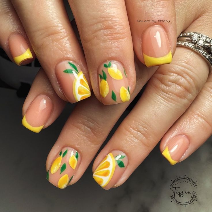 Vibrant Lemon-Themed Nail Design with Yellow French Tips and Lush Greenery Accents for a Chic, Summery Look.