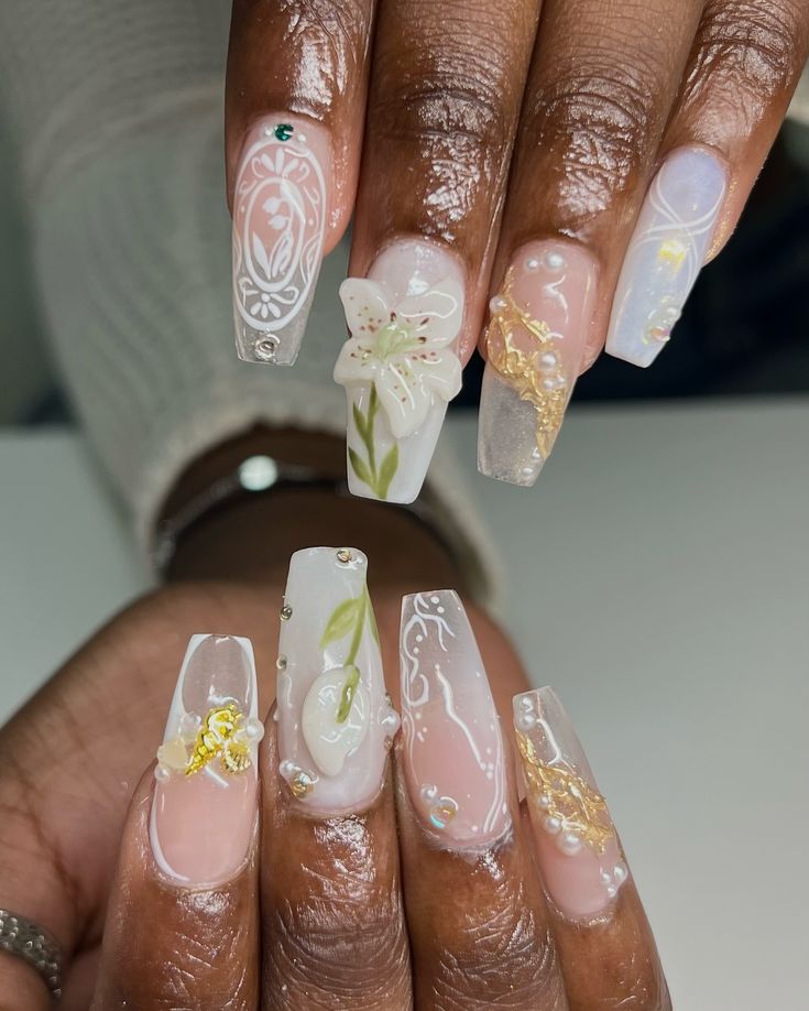 Elegant Floral and Metallic Long Nails with Gem Embellishments and Pastel Tones.