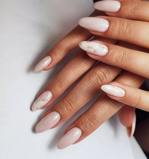 Chic Almond-Shaped Nails with Nude Base and Gold Accents.