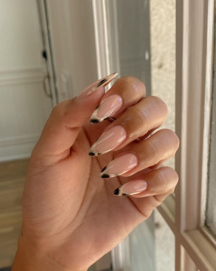 Chic Elegant Almond Nails with Nude Base and Striking Black Accents