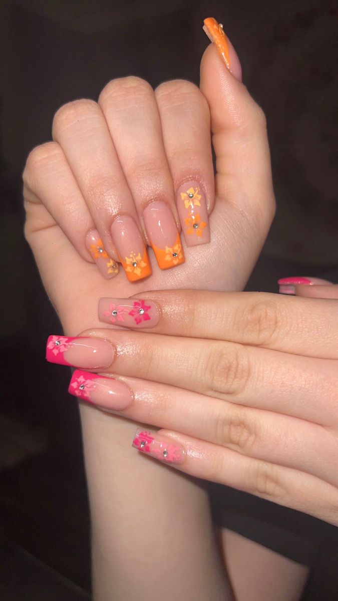 Playful Orange and Pink Floral Nail Design with Glossy Finish.