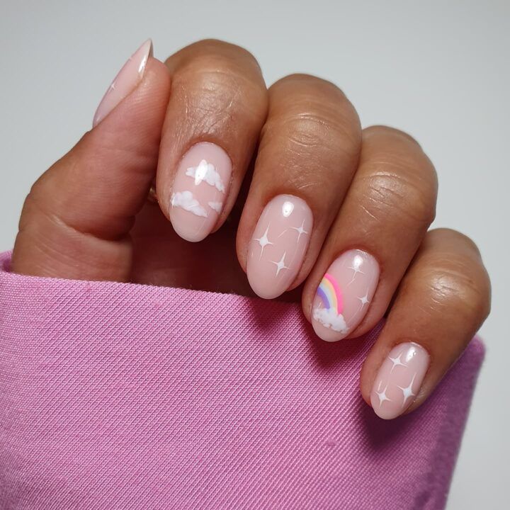 Cheerful Pastel Nail Design with Cloud, Rainbow, and Star Accents for a Creative Touch.