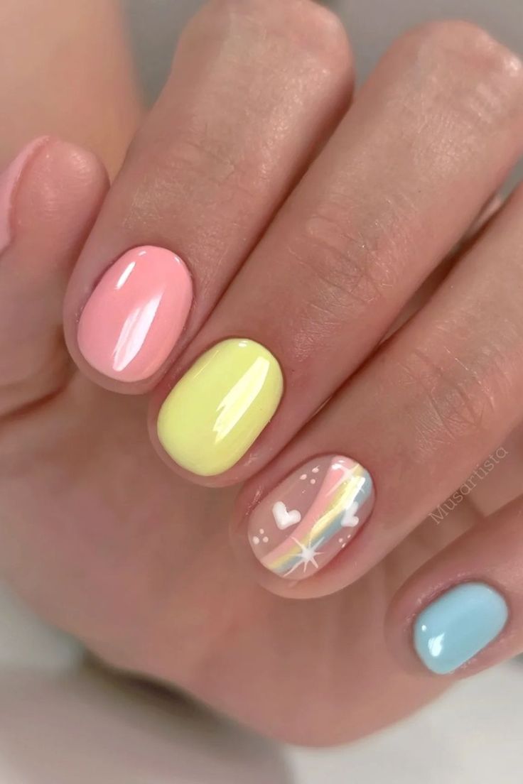 Cheerful Pastel Nail Design with Whimsical Rainbow Accent