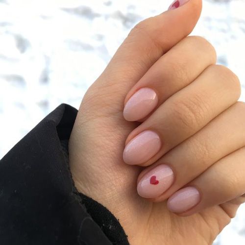 Elegant Delicate Nude Nail Design with Soft Pink Base and Playful Red Heart Accents.