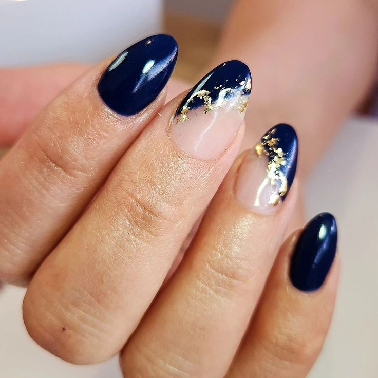 Chic Navy Blue Nail Design with Glossy Finish and Intricate Gold Accents.