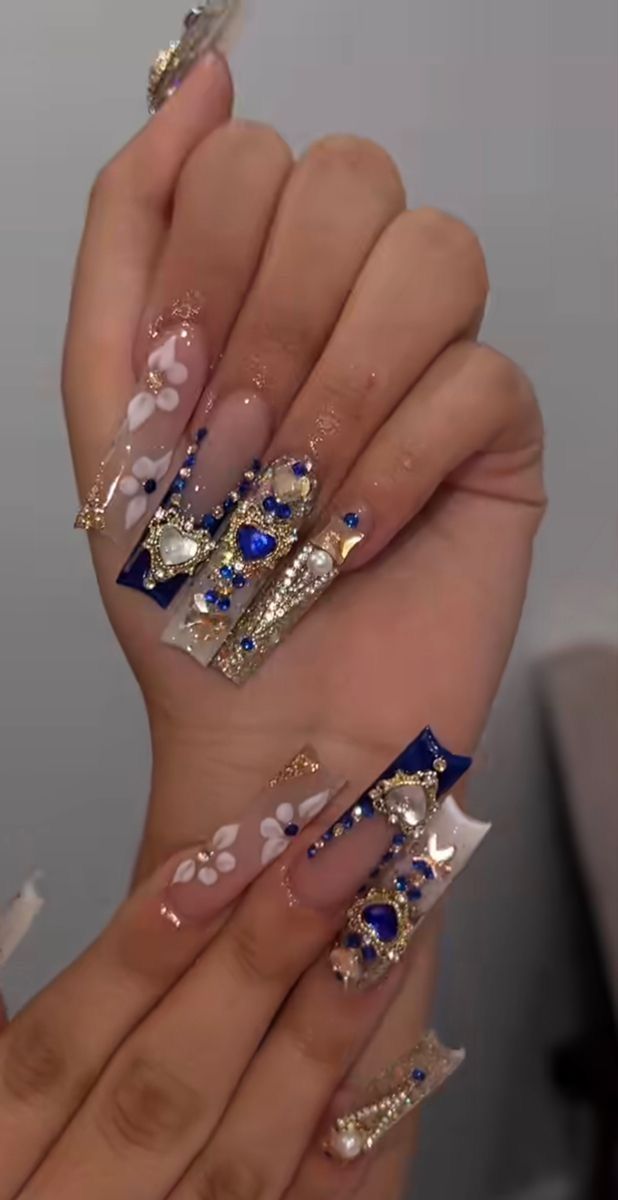 Luxurious Nail Design: Long Acrylic Extensions with Vibrant Blue, Gold Accents, and Intricate Patterns.