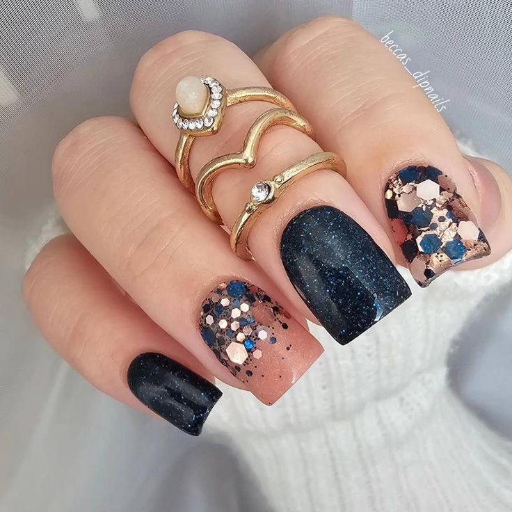 Elegant Chic Nail Design: Deep Navy Meets Earthy Tones with Glamorous Glitter and Gold Accents.