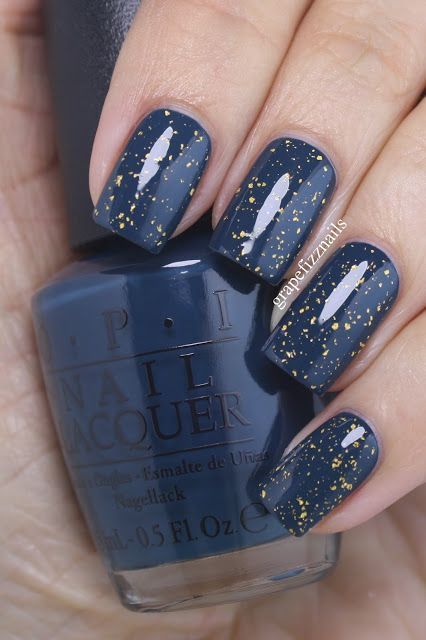 Elegant Nail Design: Deep Navy Base with Shimmering Gold Flecks