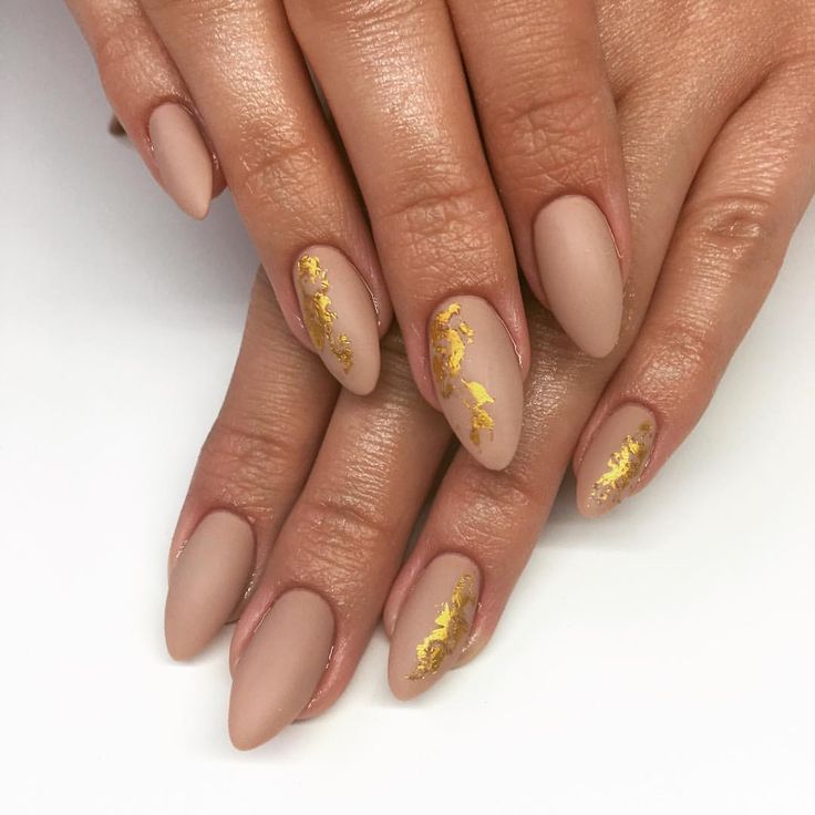 Sophisticated Almond-Shaped Nails with Matte Nude Finish and Luxurious Gold Leaf Accents