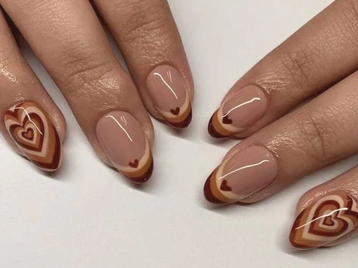 Chic Heart-Themed Nail Art: Soft Nude Base with Bold Brown and Red Patterns