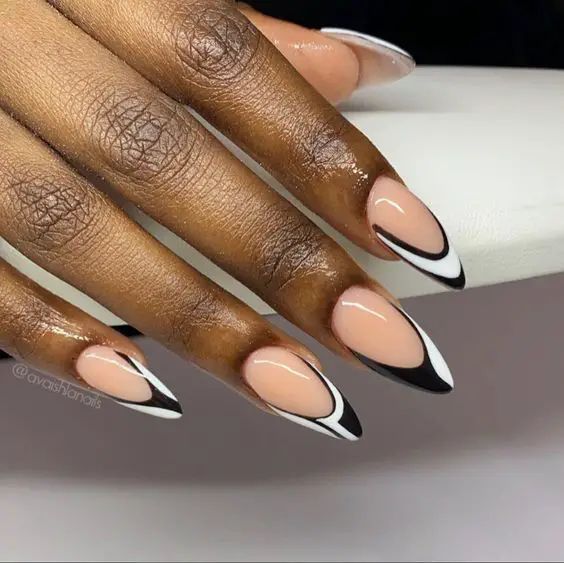 Chic Almond-Shaped Nail Design with Nude and Bold Black Accents