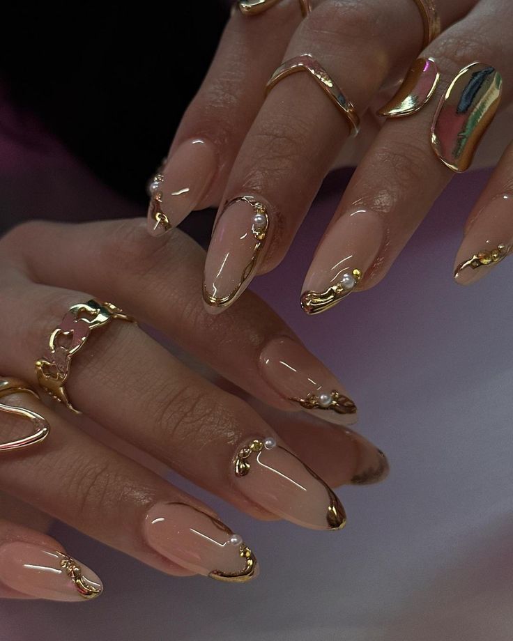 Sophisticated Nude Nail Design with Delicate Gold Accents and Minimalist Pearls.