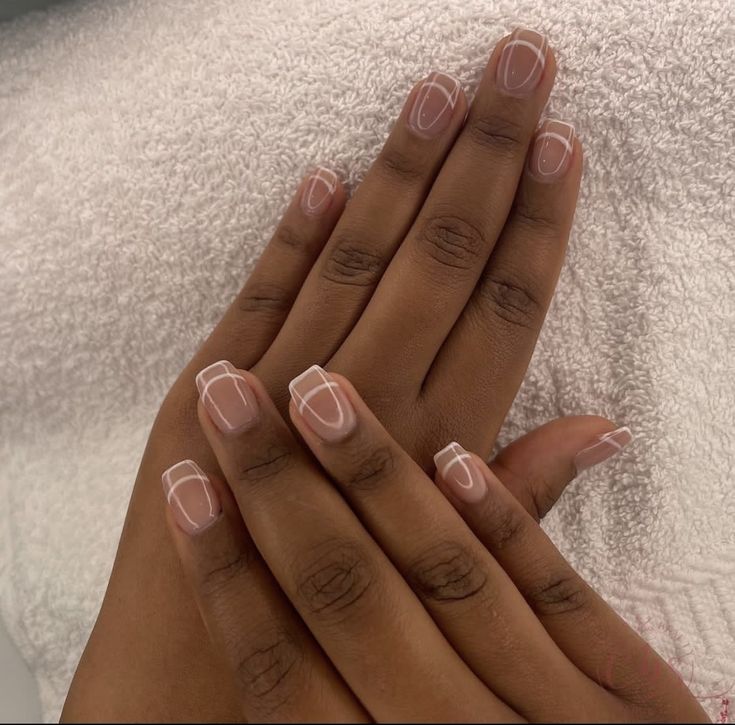 Chic Nude Nail Design with Minimalist White Outlining for Modern Elegance.