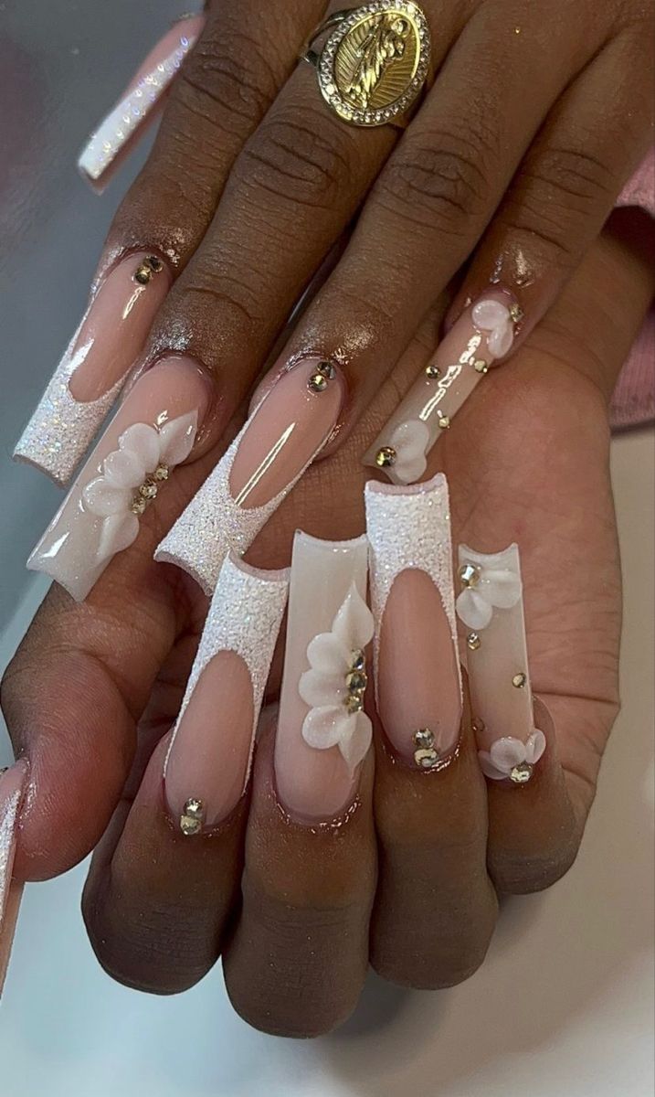 Elegant Floral Nail Design with Elongated Square Tips and Glamorous Gold Accents.