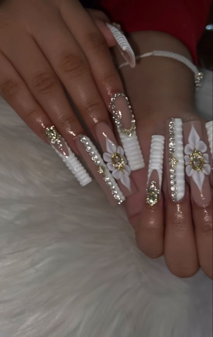 Luxurious Stiletto Acrylic Nails with Intricate Floral Patterns and Sparkling Embellishments.