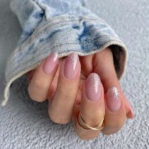 Chic Soft Pink Ombre Nail Design with Sparkly Tips and Feminine Rounded Shape.