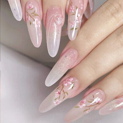 Romantic Pink Gradient Nail Design with Floral Accents and Gold Detailing.