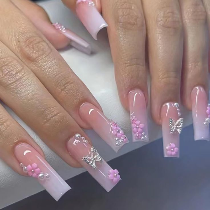 Whimsical Ombre Nail Design with Floral Accents and Glamorous Pearls