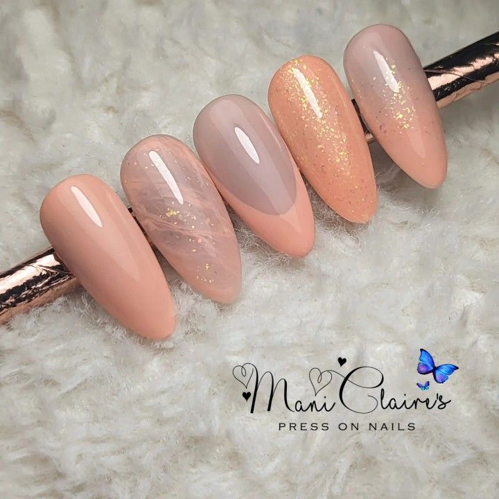 Chic Nude Nail Design with Shimmering Accents and Unique Marbled Effect.