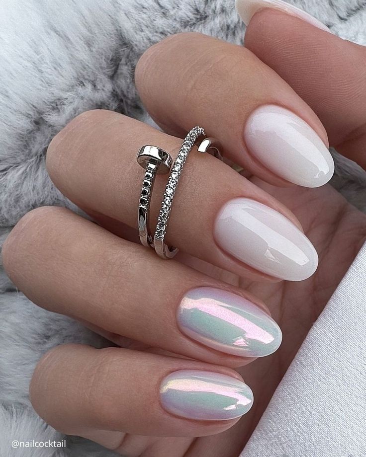 Chic Nail Design: Glossy White and Iridescent Elegance with Silver Accents.