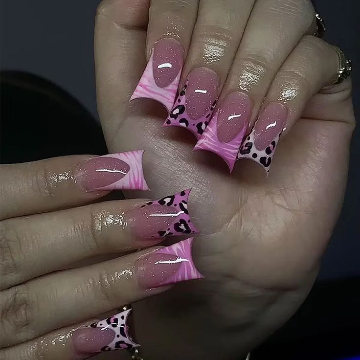 Trendy Pink Gradient Nail Design with Playful Patterns and Leopard Accents.