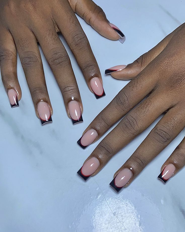 Chic Sophistication: Soft Nude Base with Bold Black Tips Nail Design