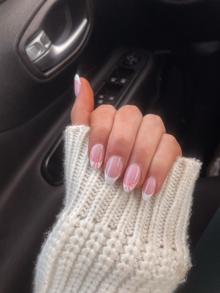 Charming Soft Pink Nail Design with Delicate White French Tips and Floral Accents