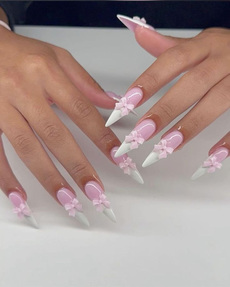 Chic Pastel Pink and White Nail Design with Dramatic Shapes and Playful 3D Bows.