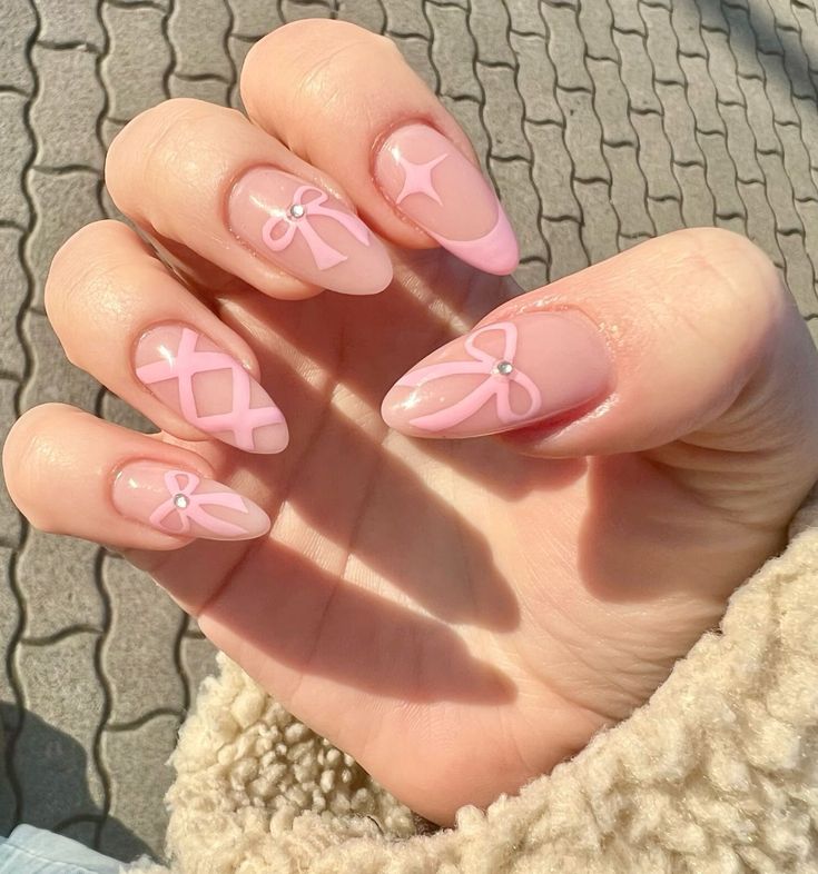 Whimsical Pink Nail Design with Cute Embellishments and Elegant Pearls.