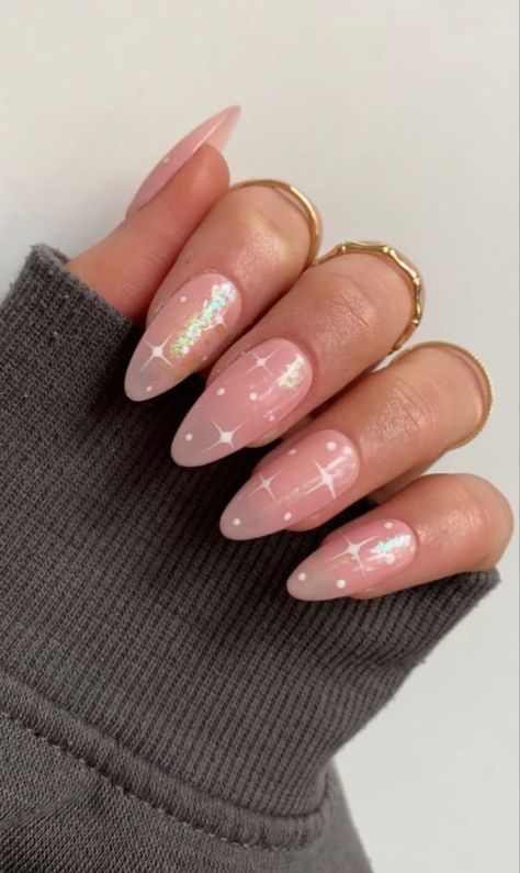 Chic Soft Pink Nail Design with White Stars and Iridescent Accents.