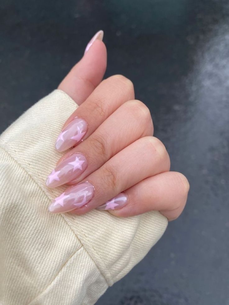 Ethereal Nail Design: Whimsical Pink Base with Star Patterns