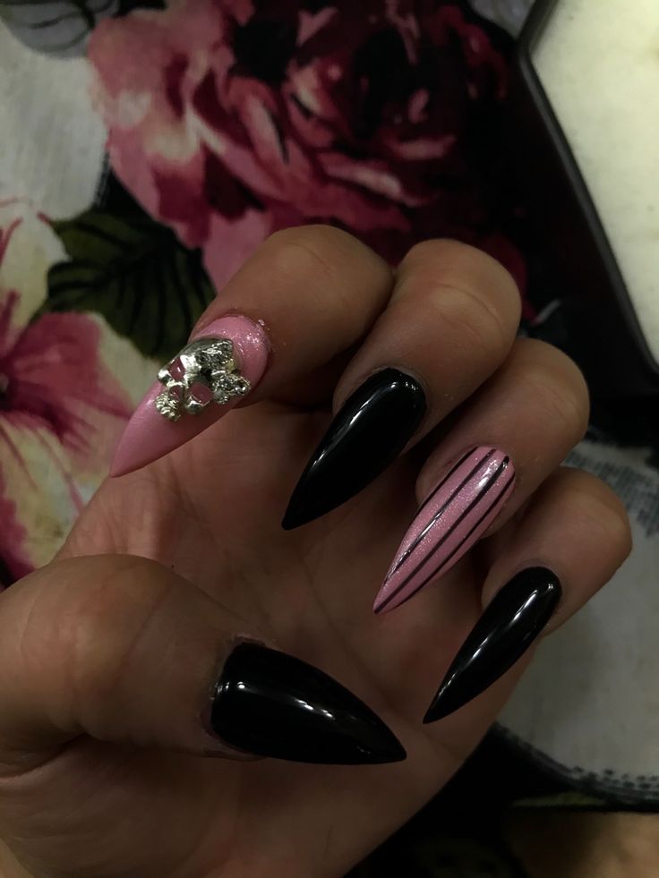 Elegant Almond-Shaped Nail Design in Bold Black and Soft Pink with Glamorous Detailing.