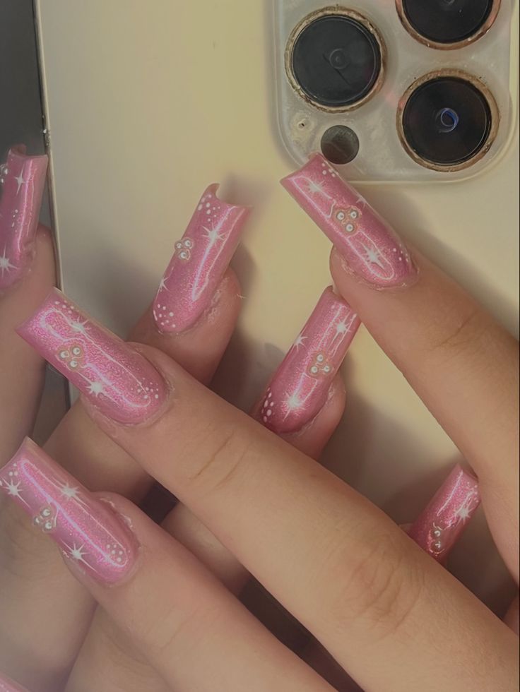 Elegant Pink Acrylic Nails with Sparkly Accents for a Chic, Playful Look.