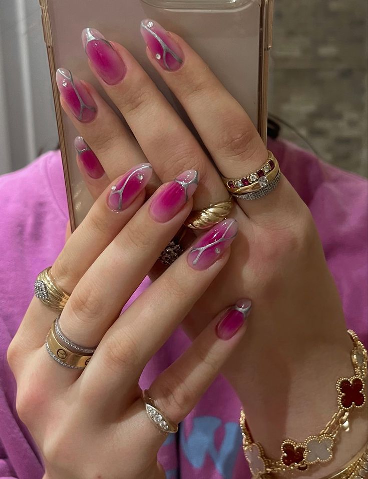 Chic Pink Ombre Nails with Swirls, Pearls, and Stylish Rings.