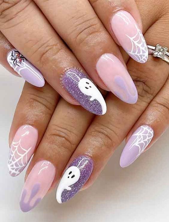 Charming and Spooky Pastel Halloween Nail Design with Ghosts and Spider Webs.