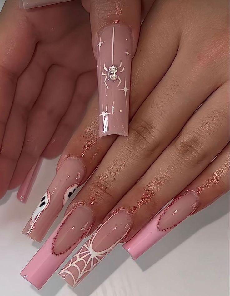 Elegant Pastel Pink Nail Design with Intricate Motifs and Sparkling Embellishments