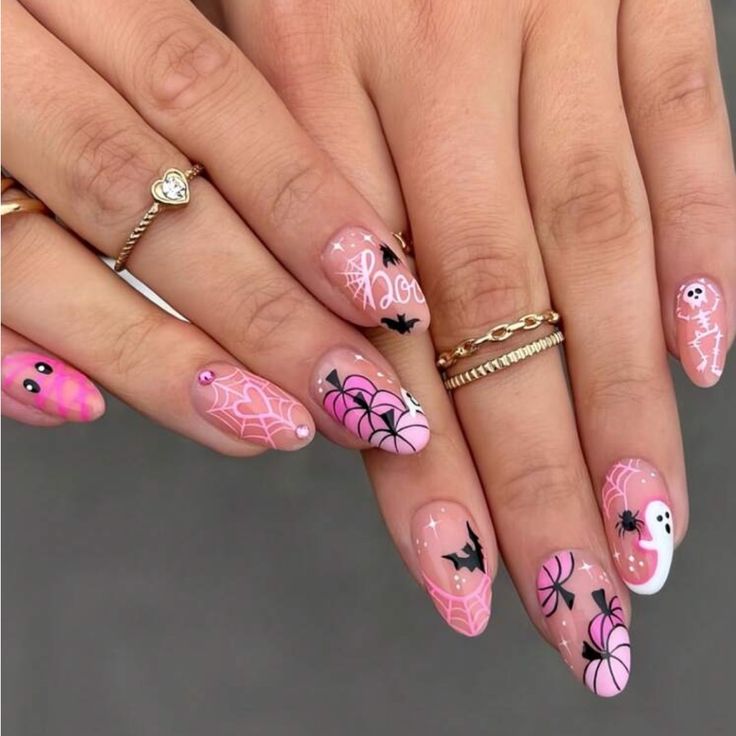 Whimsical Halloween Nail Art: Pink and Pastel Designs with Ghosts, Bats, and Spider Webs.