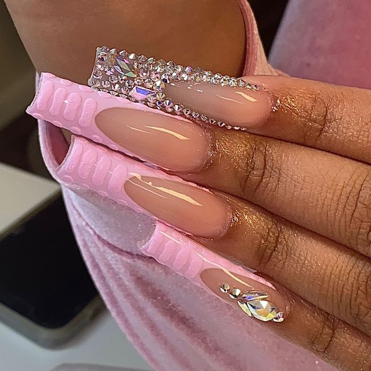 Chic Nail Art: Glossy Nude Extensions with Intricate Pink Accents and Sparkling Rhinestones.