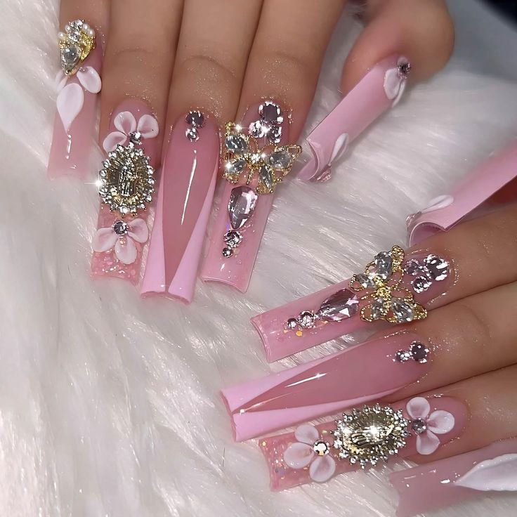 Elegant Long Pink Acrylic Nail Design with Floral Accents and Gemstone Embellishments.